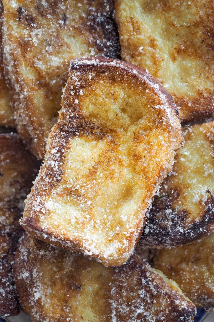 These Traditional Torrijas or Spanish Style French Toasts are homemade and so easy to make. They are creamy on the inside and have a cinnamon sugar coating. Plus, they are the perfect excuse to make the most of stale bread. If you love French toasts, you will love this delicious Spanish Easter dessert. | Paula's Apron Recipe