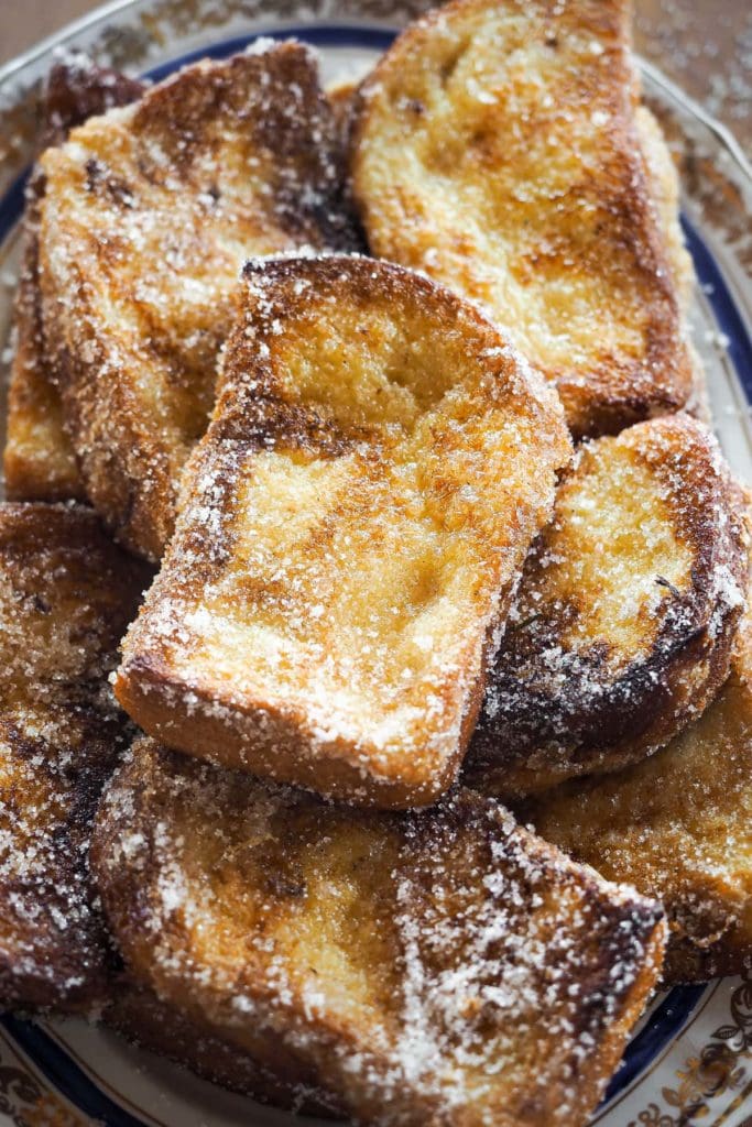 These Traditional Torrijas or Spanish Style French Toasts are homemade and so easy to make. They are creamy on the inside and have a cinnamon sugar coating. Plus, they are the perfect excuse to make the most of stale bread. If you love French toasts, you will love this delicious Spanish Easter dessert. | Paula's Apron Recipe