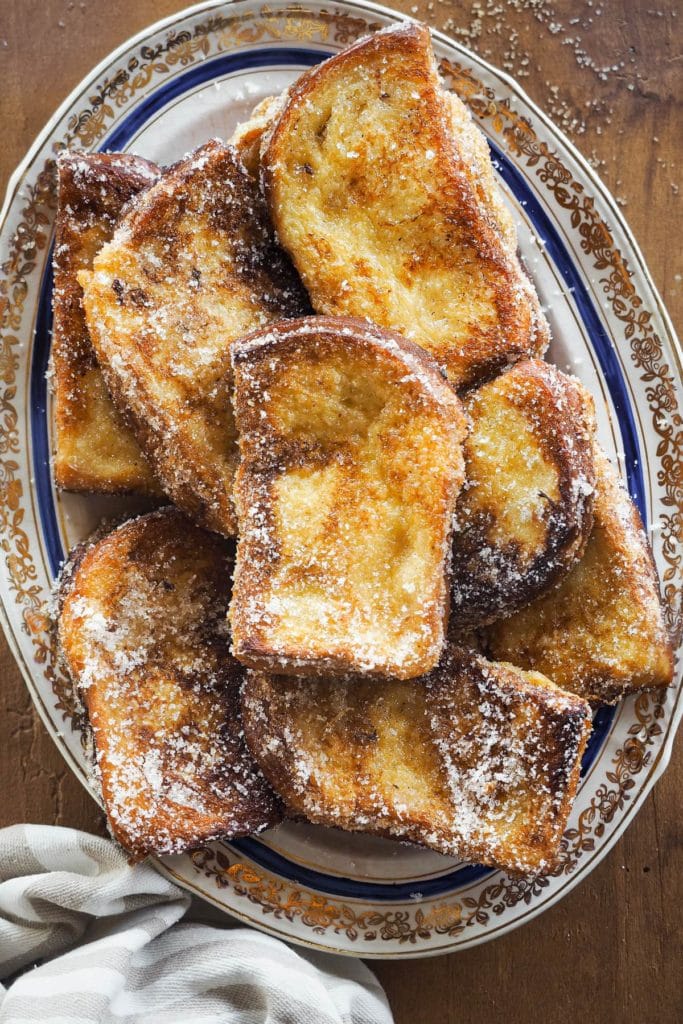 These Traditional Torrijas or Spanish Style French Toasts are homemade and so easy to make. They are creamy on the inside and have a cinnamon sugar coating. Plus, they are the perfect excuse to make the most of stale bread. If you love French toasts, you will love this delicious Spanish Easter dessert. | Paula's Apron Recipe