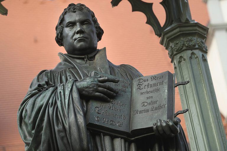 WITTENBERG, GERMANY - OCTOBER 20: A statue of 16th-century theologian Martin Luther stands on Marktplatz square on October 20, 2016 in Wittenberg, Germany. In 1517 Luther nailed his 95 theses to a door of the nearby Schlosskirche Church. Next year will mark the 500th anniversary of the Reformation that Luther set in motion and that led to the creation of successful Protestant movements in history's most significant challenge to the Catholic Church. Celebrations and events in Germany will begin later this month and continue globally through next year. Luther's translation of the Bible made it accessible to a much broader audience. He also spoke out against the practice of indulgences and the sale of relics, and also argued that a place in Heaven is possible not by good deeds but through faith. (Photo by Sean Gallup/Getty Images)