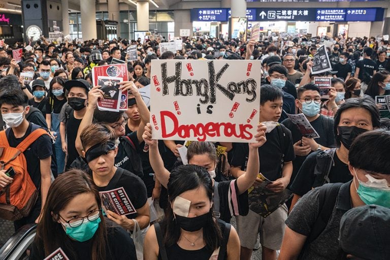HONG KONG, CHINA - AUGUST 12: Protesters occupy the arrival hall of the Hong Kong International Airport during a demonstration on August 12, 2019 in Hong Kong, China. Pro-democracy protesters have continued rallies on the streets of Hong Kong against a controversial extradition bill since 9 June as the city plunged into crisis after waves of demonstrations and several violent clashes. Hong Kong's Chief Executive Carrie Lam apologized for introducing the bill and declared it "dead", however protesters have continued to draw large crowds with demands for Lam's resignation and completely withdraw the bill. (Photo by Anthony Kwan/Getty Images)