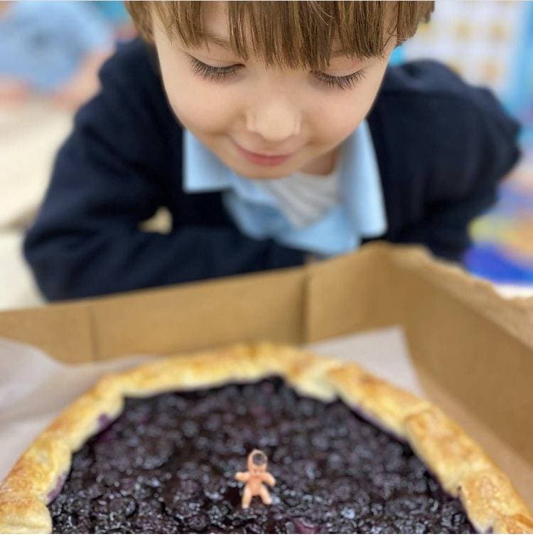 preschooler with a fruit pastry