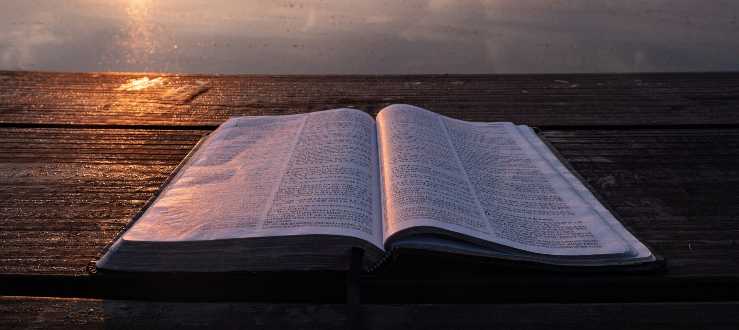 Open Bible by the water