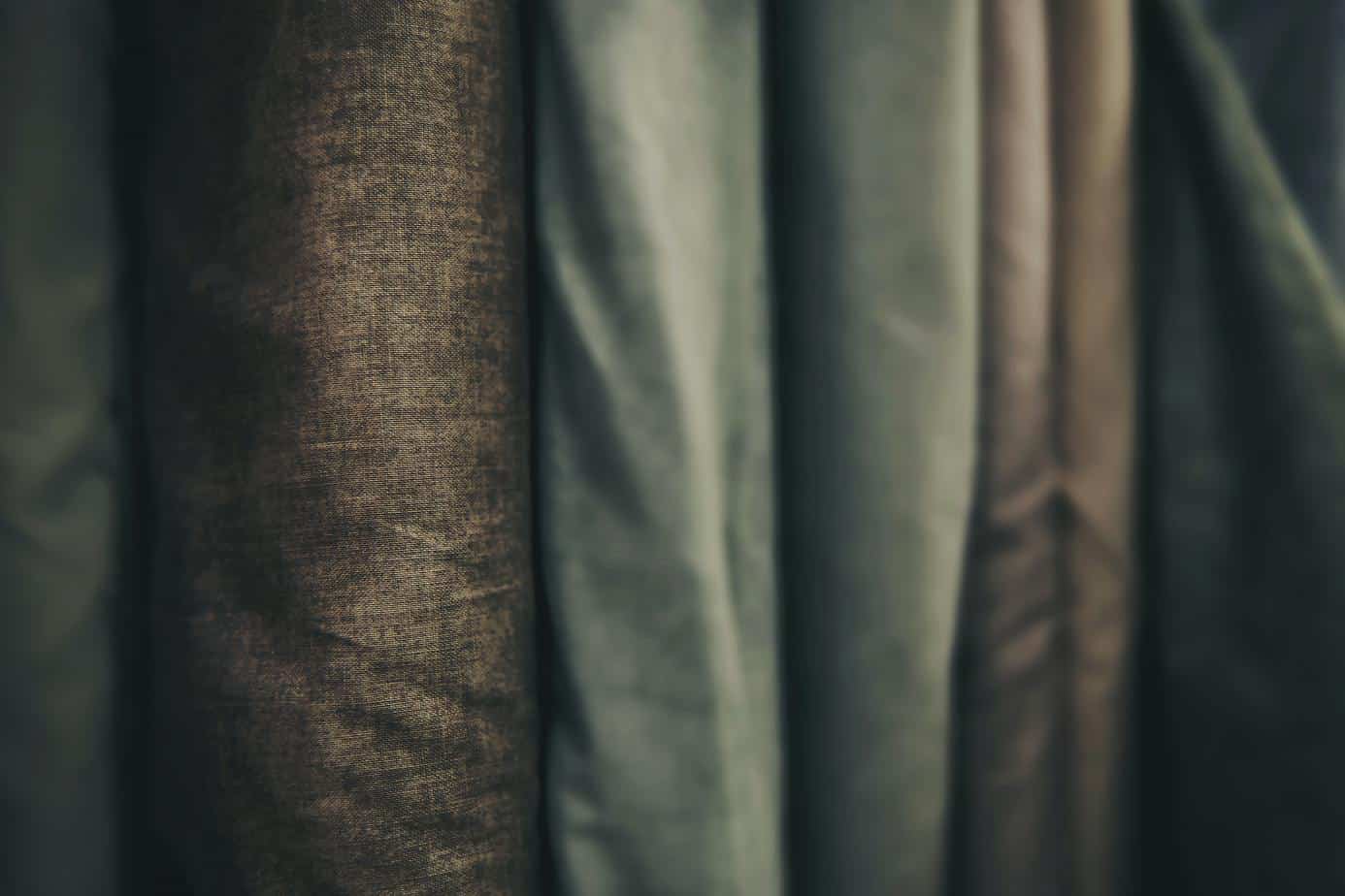 Dark toned fabrics lined up on bolts - home shows on tv on amazon PBS Netflix YouTube