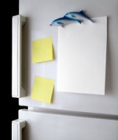 2 post it notes and some paper on a fridge door