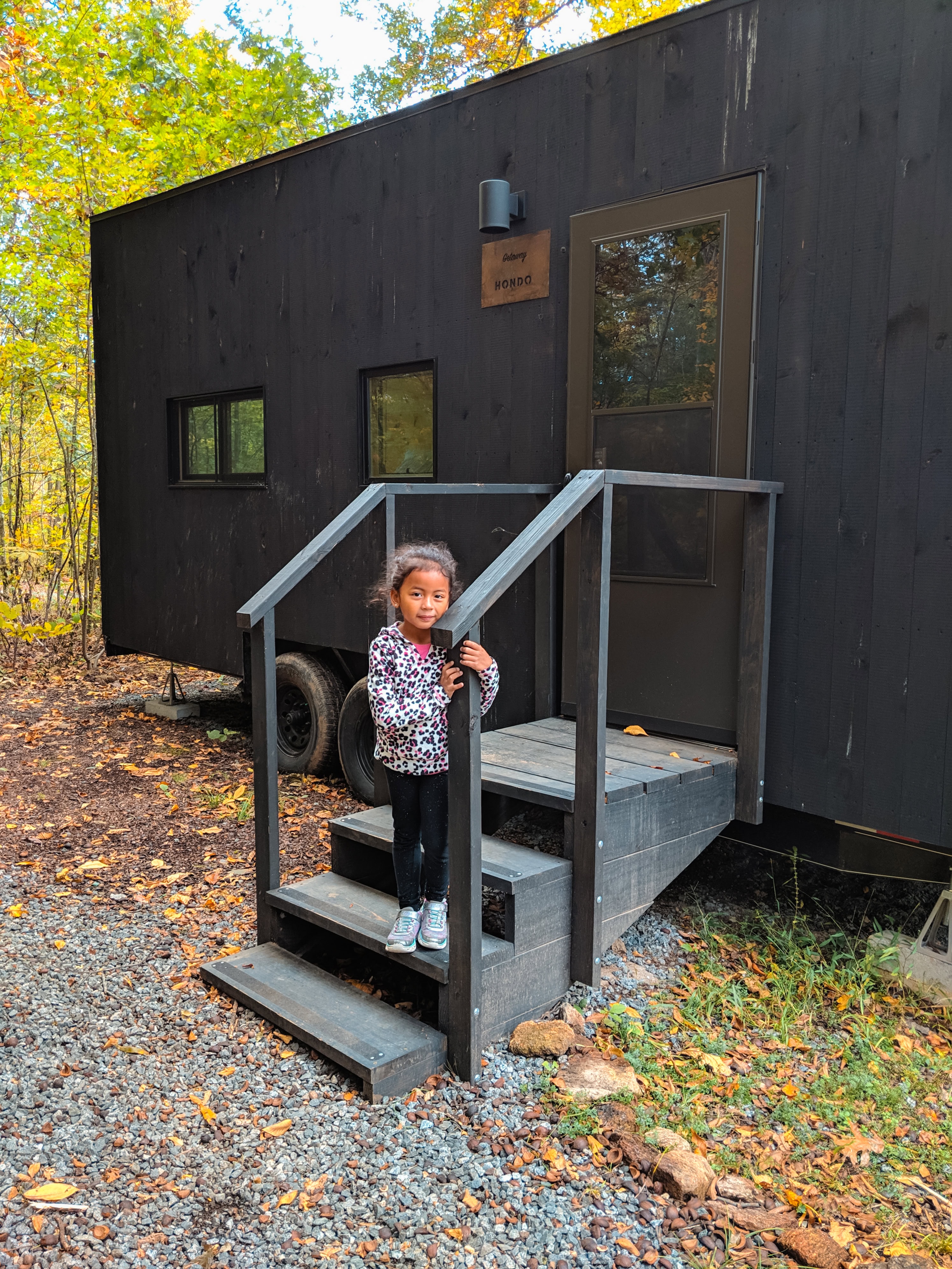 Child standing in front of Postcard Cabin