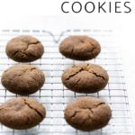 Molasses cookies on a cooling rack with text overlay that says "soft & chewy molasses cookies"