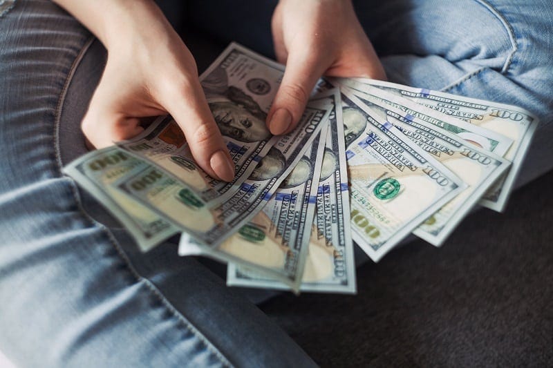 person holding pile of money