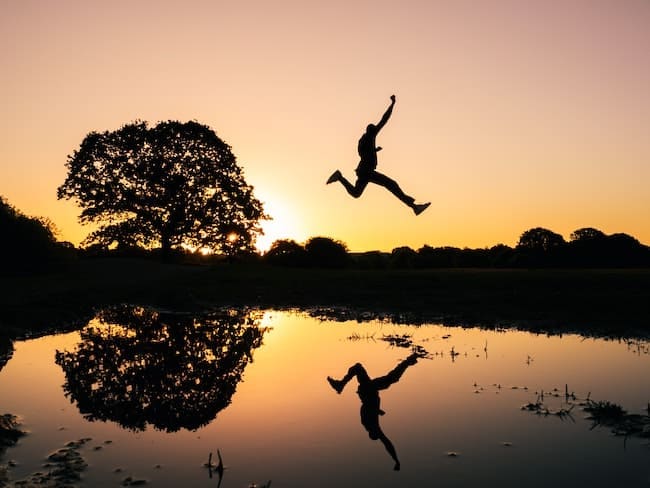 man taking big leap