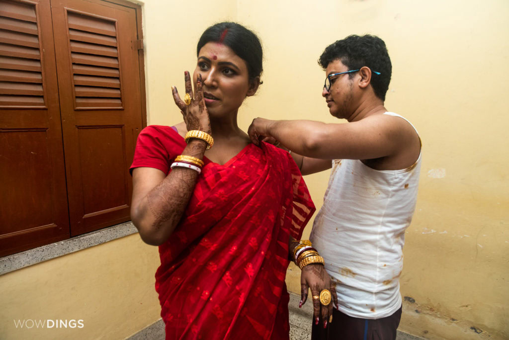 Dipan helps Tista , a transgender couple, to manage her saari at their home