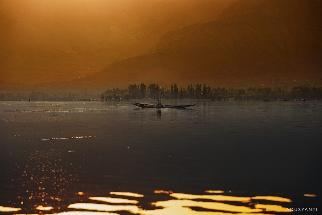 boatman at dal lake during sunset