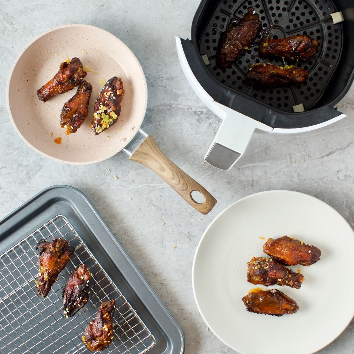 chicken wings in 5 different vessels