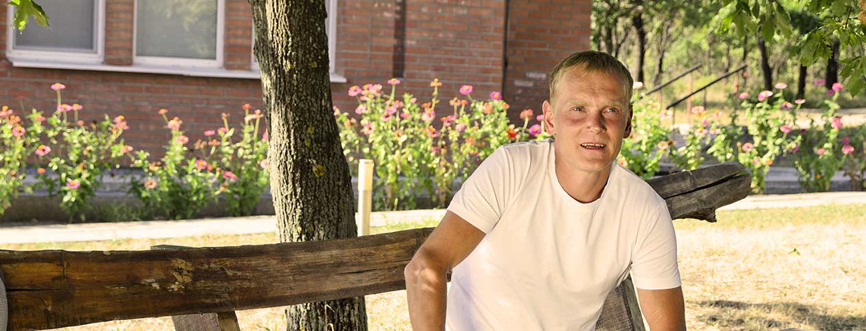 Man sitting on bench having a successful alcohol rehab