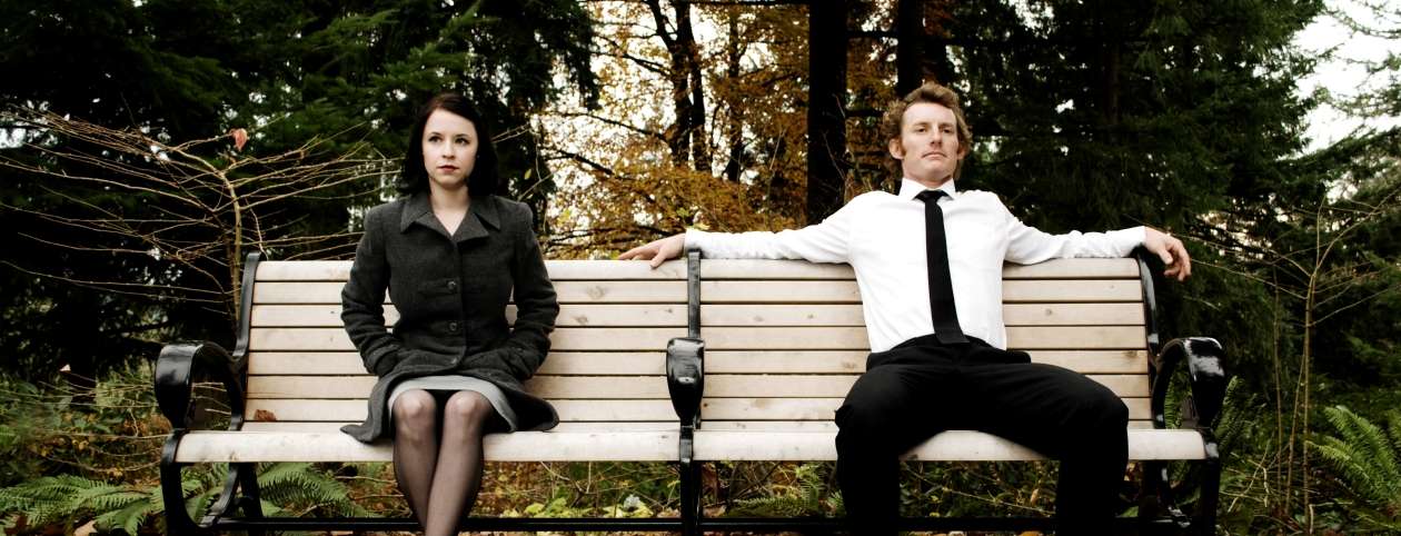 Couple sitting on bench marriage counseling