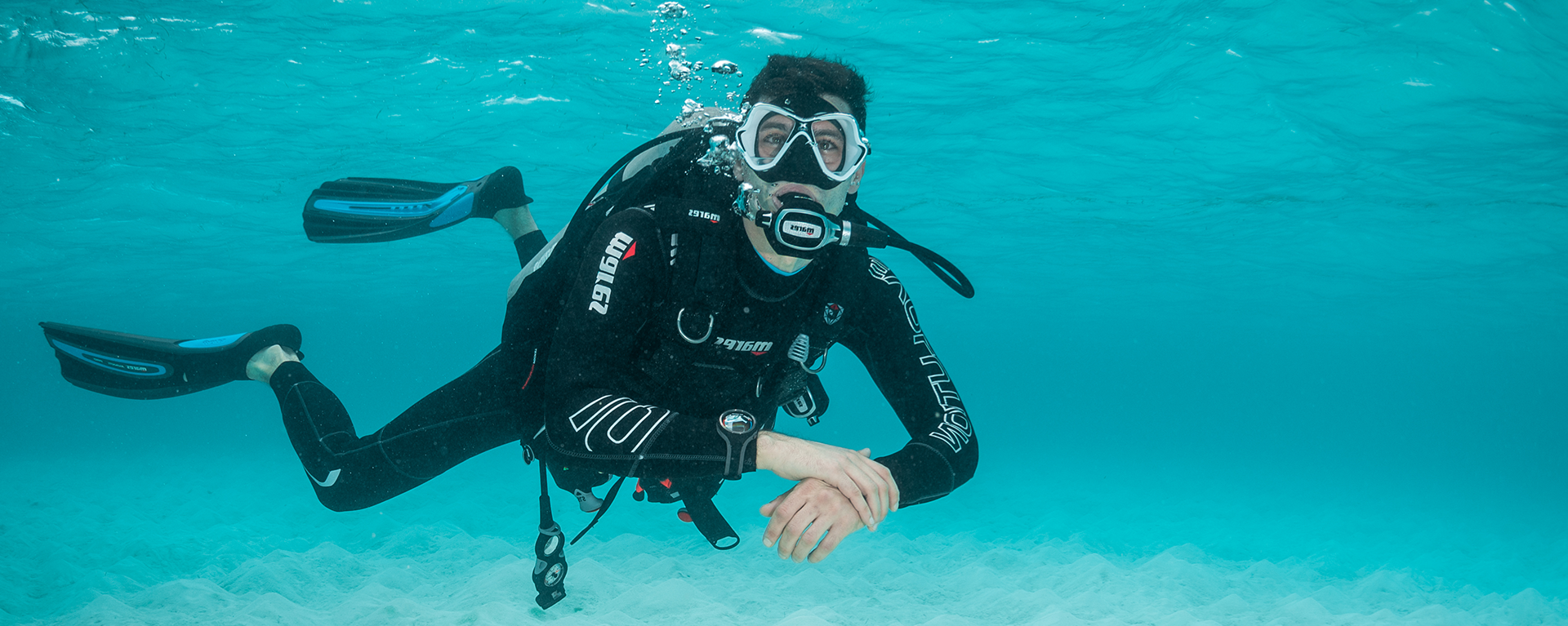 Male scuba diver in shallow water