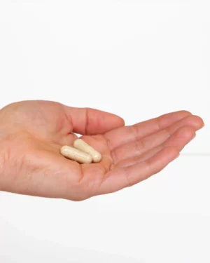 Hand holding a couple capsules