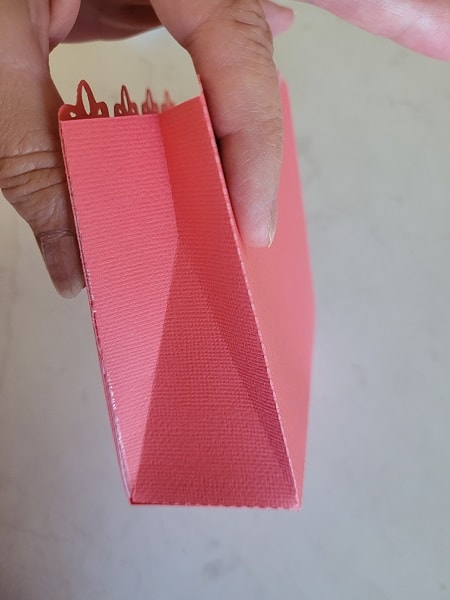 Once you have the sides glued together give them a quick pinch and squeeze the fold lines inwards.