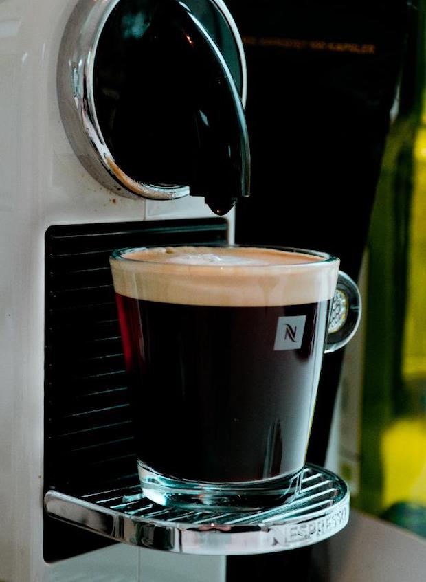 Long espresso on the drip tray of a Nespresso machine