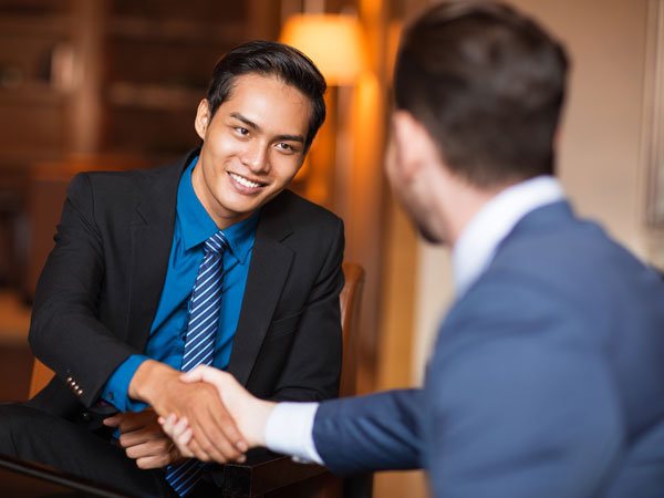 2 businessmen shaking EZ Money Sdn Bhd.