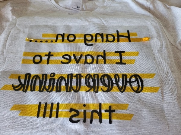 The HTV T-Shirt design ready to be ironed on showing the missing exclamation dots