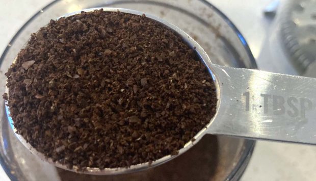 Coffee ground to the correct size for French press in a tablespoon measure