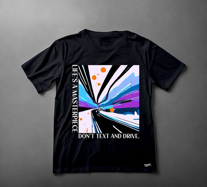 Black T-shirt with a colorful abstract road illustration and the words Life’s a masterpiece and Don’t text and drive.