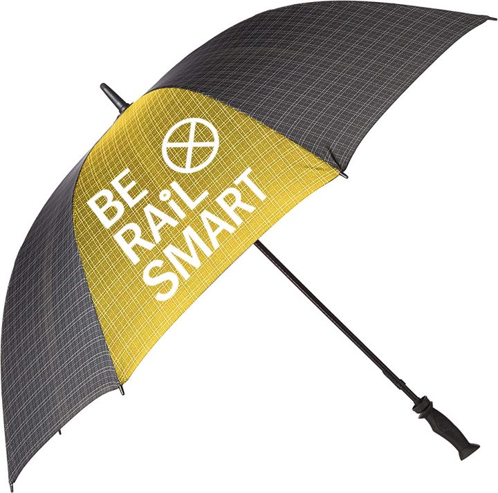 Black and yellow umbrella printed with the Be Rail Smart railroad-crossing logo.