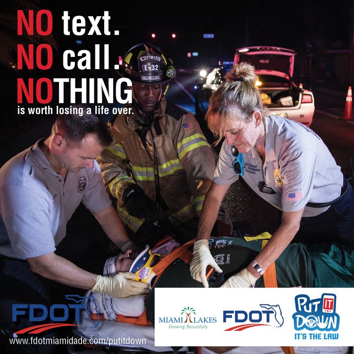 Firefighters treating a crash victim at night beside the words No text. No call. Nothing is worth losing a life over.