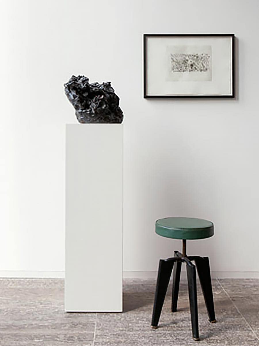 Arrangement of picture, sculpure and green swivel stool in the office of Designer Oliver Jungel