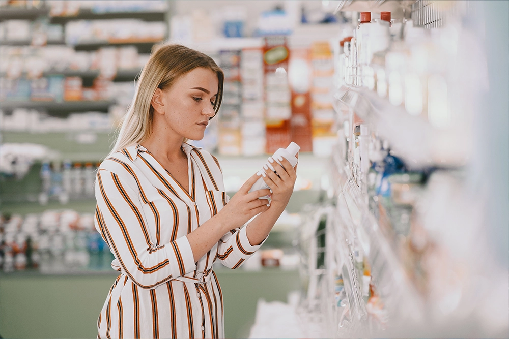Woman Checking Supplement Label