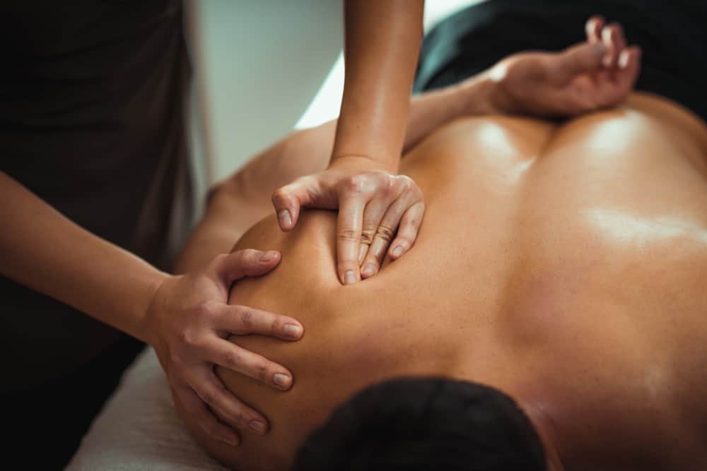 A sports therapist is performing massage therapy to a patient at seventy9 Sports Therapy, a sports injury clinic in Guildford, sports therapy in Guildford, sports massage in Guildford, sports therapy clinic in Guildford, sports massage clinic in Guildford, massage in Guildford