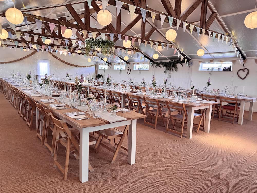 Banquet style wedding reception seating with three long tables and no top table