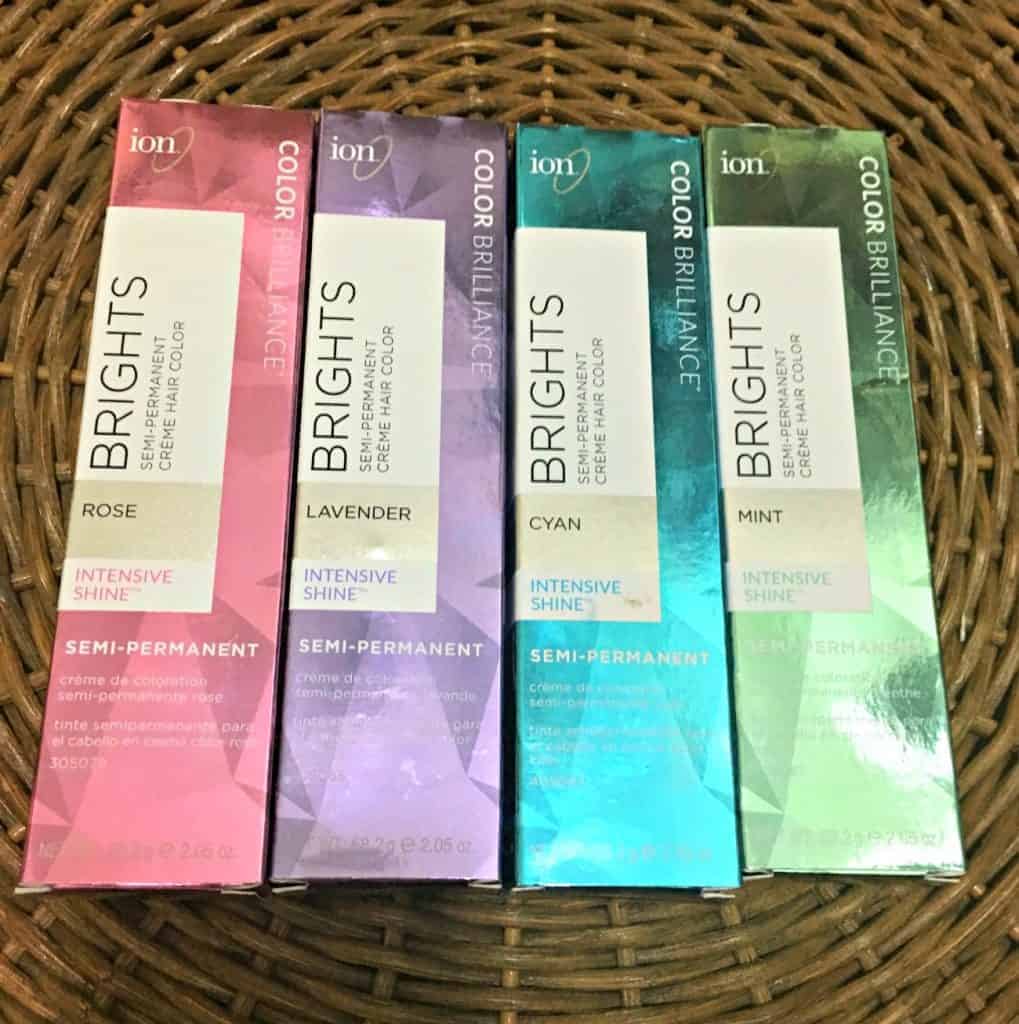 boxes of pink purple blue and green hair dye arranged next to each other.