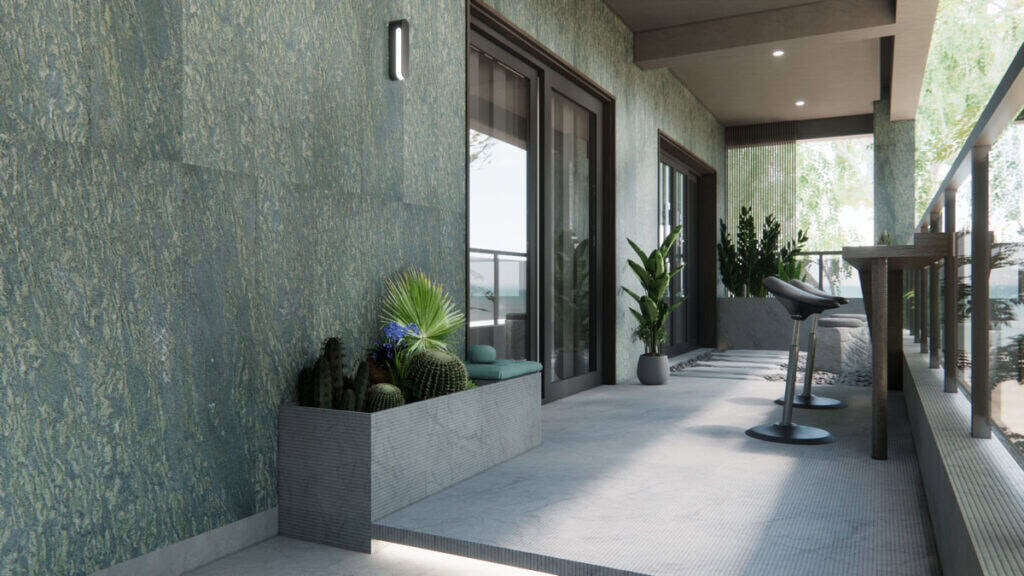 Фасад дома, облицованный бучардированным зелёным гранитом