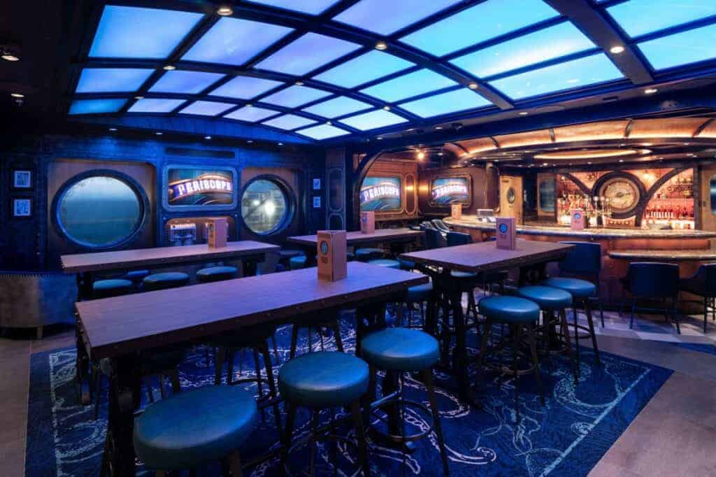 On board the Disney Treasure, Disney Cruise Line’s newest ship, guests dive into the mythical depths of uncharted oceans at the Periscope Pub. Serving as Disney Cruise Line’s first venue inspired by the spellbinding adventure of Walt Disney’s 1954 film, “20,000 Leagues Under the Sea” and the legacy Disney Parks attraction, the submarine-styled interiors give guests a look at the watery world below through an intriguing glass ceiling. (Kent Phillips, photographer)