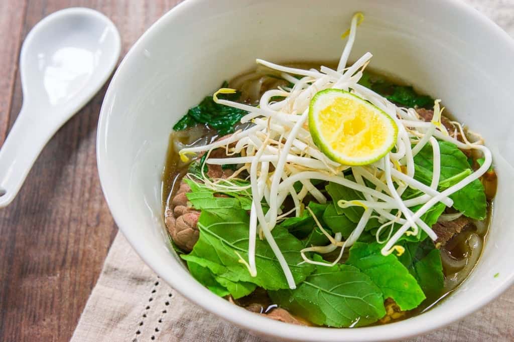 Pho Tai Nam (Beef Pho Recipe) A plate of condiments such as basil, cilantro, bean sprouts and lime allow you to customize your own bowl of pho.