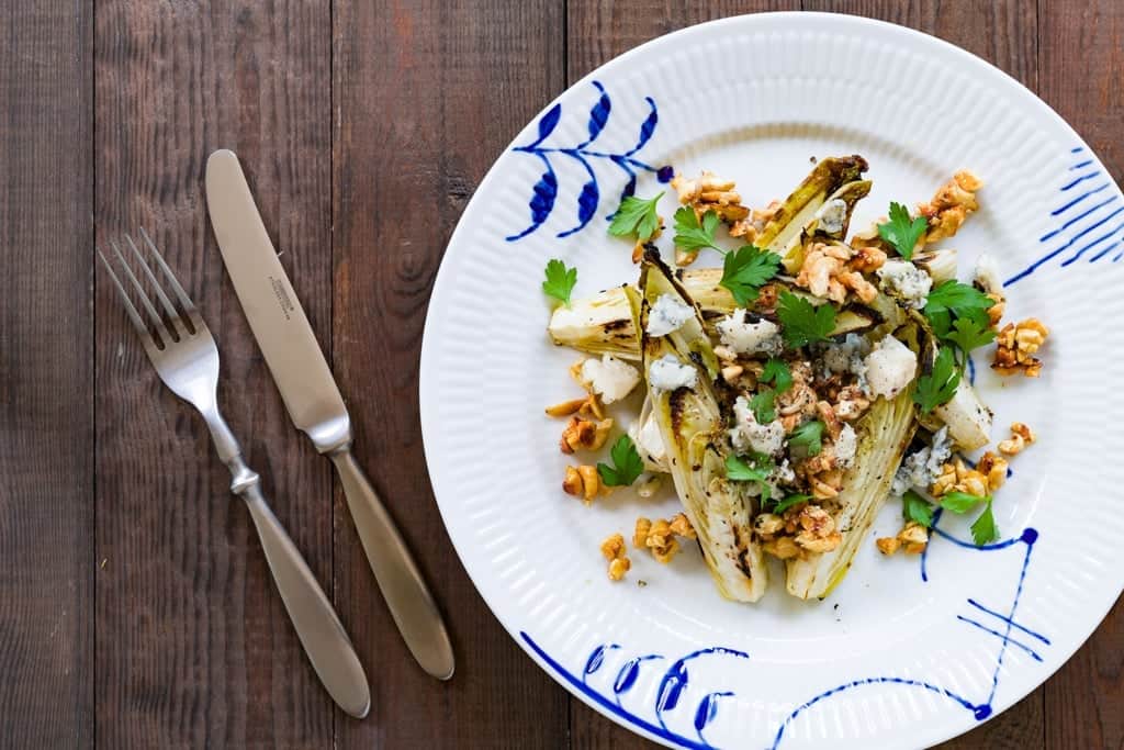 Grilled Endive Salad Marinated and grilled endive wedges with gorgonzola and honey roasted cashews.
