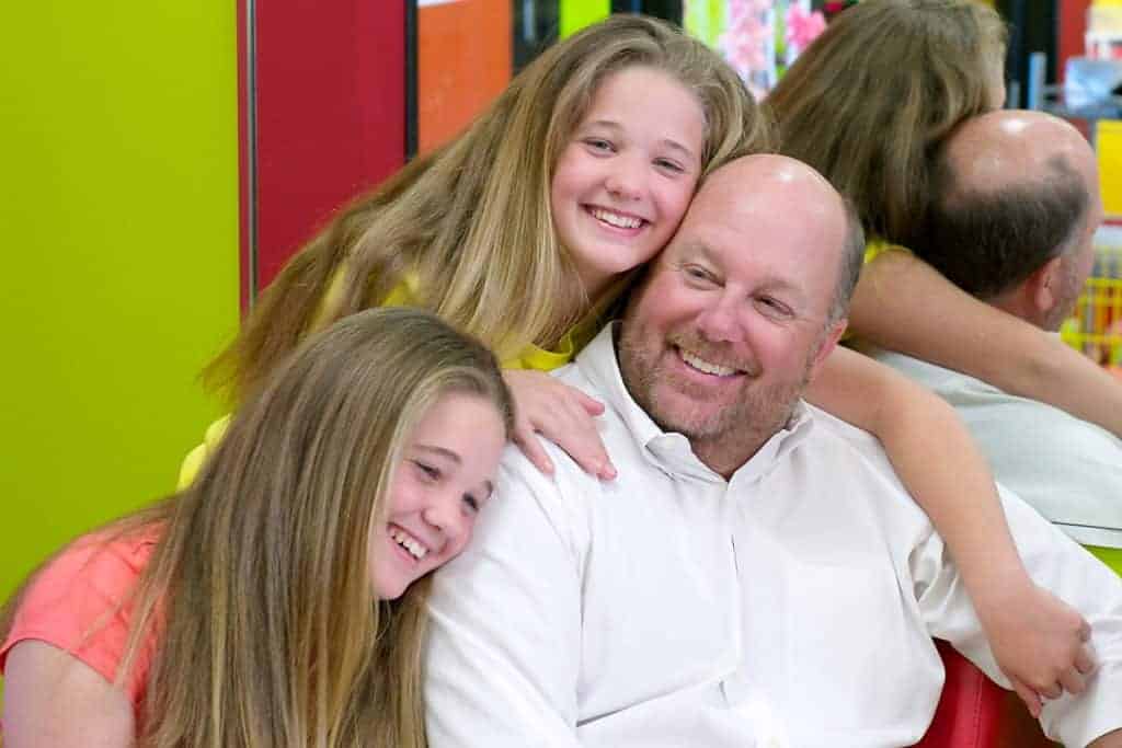 Wade Brannon in a Pigtails & Crewcuts salon with his daughters