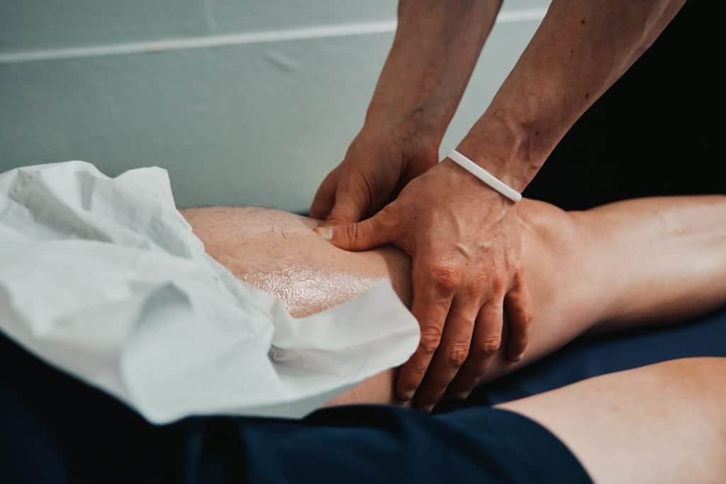 A sports therapist is performing massage therapy to a patient at seventy9 Sports Therapy, a sports injury clinic in Guildford, sports therapy in Guildford, sports massage in Guildford, sports therapy clinic in Guildford, sports massage clinic in Guildford, massage in Guildford