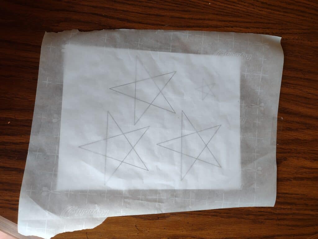 Picture of star pattern underneath a piece of parchment paper
