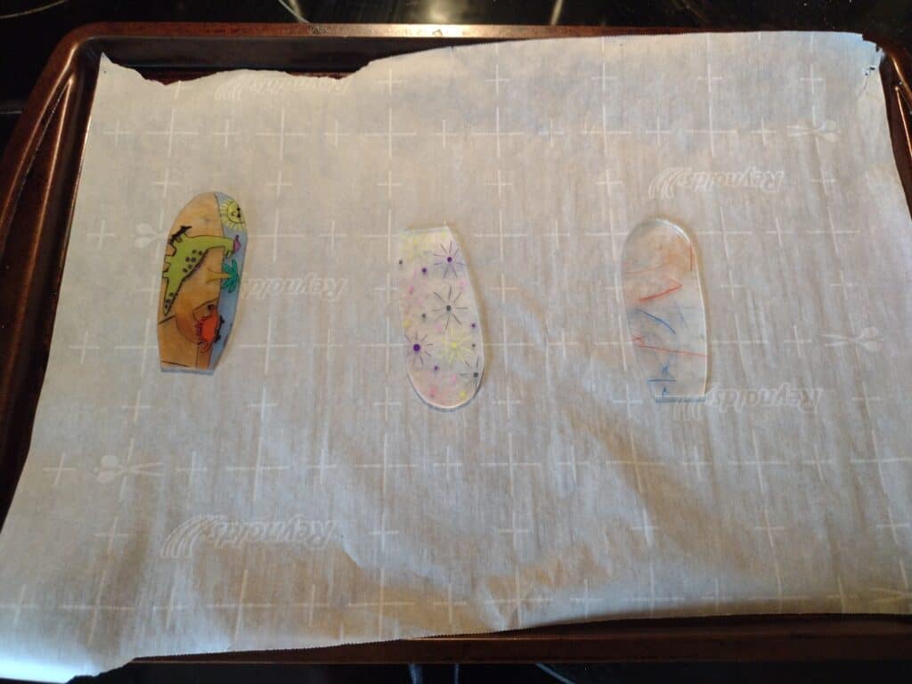 Picture of three flower petal shaped Shrinky Dinks for a pinwheel after shrinking
