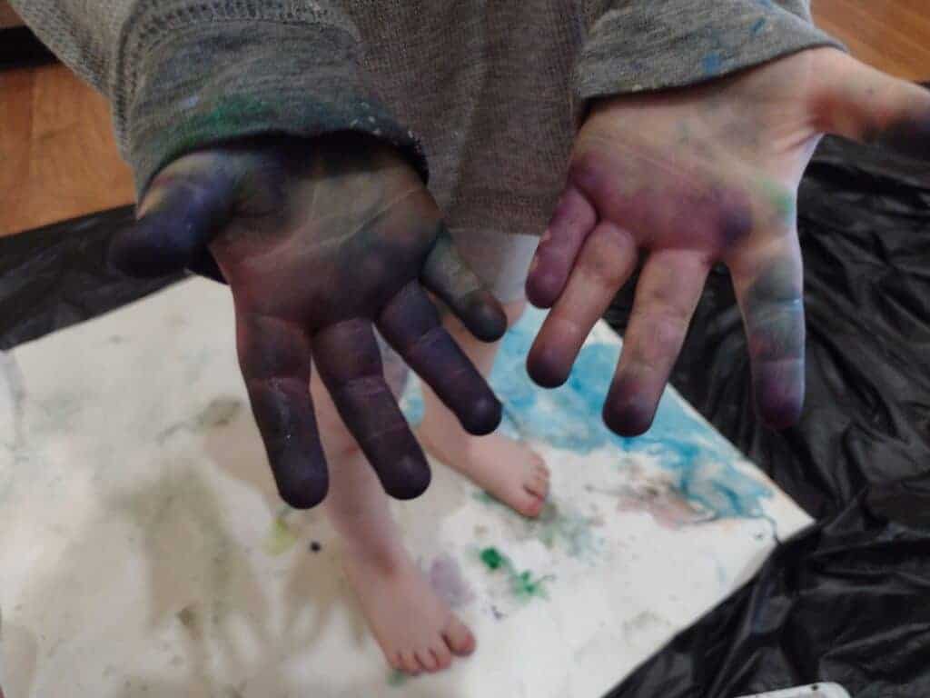 Picture of a preschooler's hands covered in food coloring after painting with ice