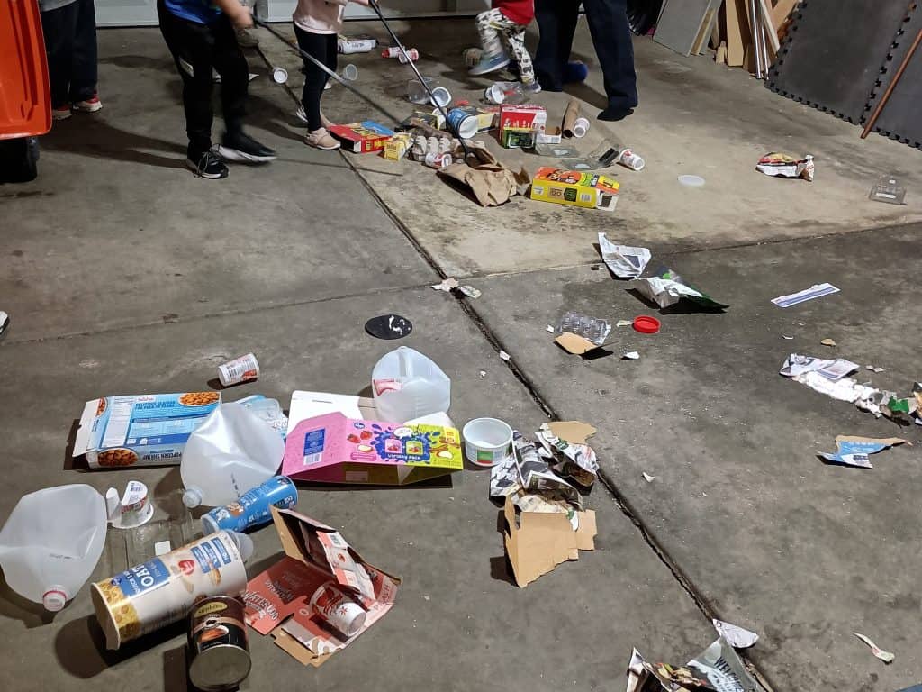 Picture of kids picking up trash with claws
