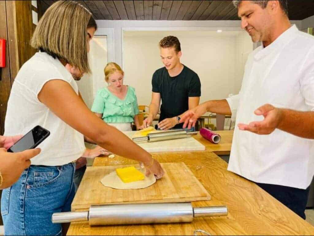 Group making pastel de nata in a cooking class in Lisbon