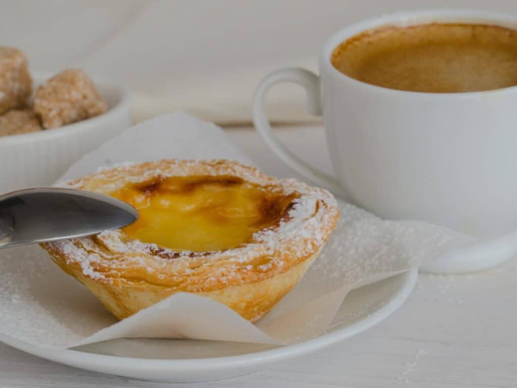 Pastel de Nata and coffee are some of the foods served on Lisbon food tours.