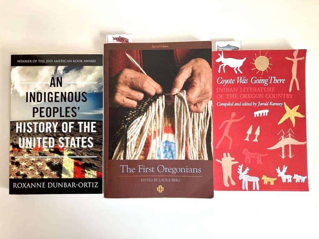 Three books about Indigenous peoples lying on a table