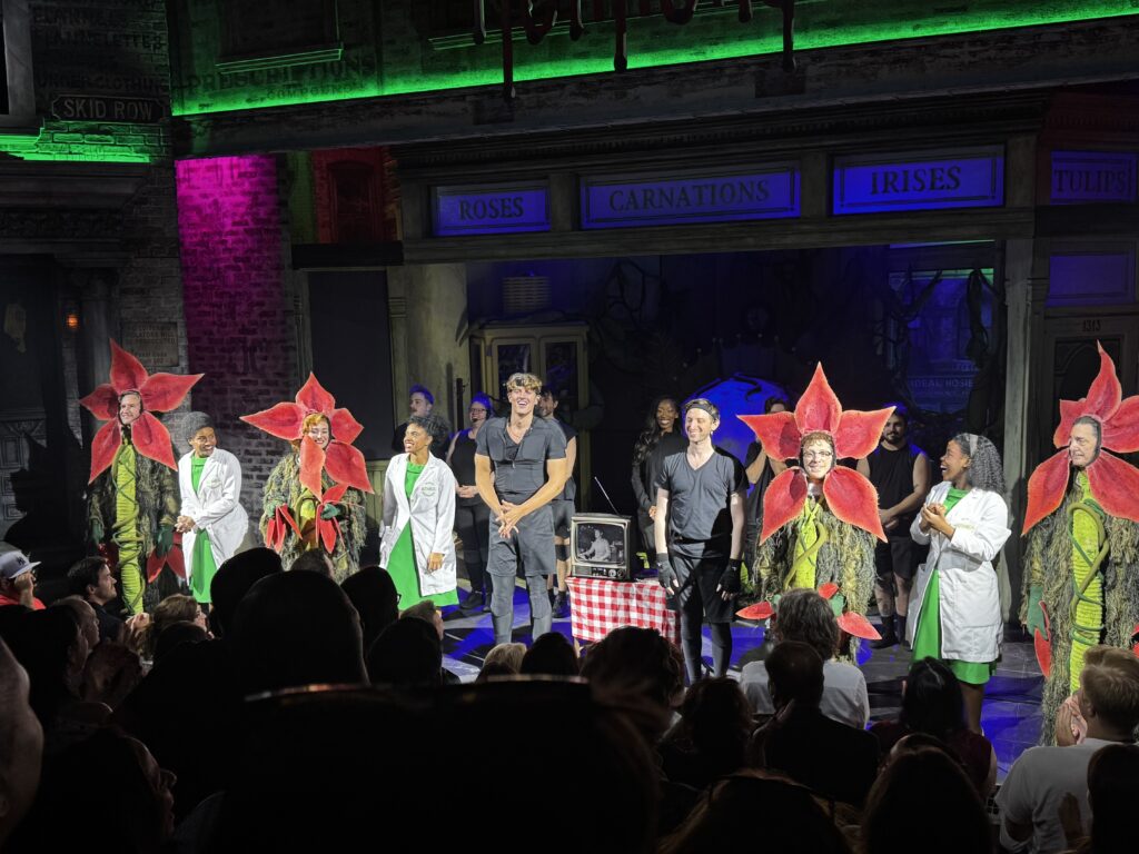 Cast of Little Shop of Horrors performs Suddenly Seymour with audience