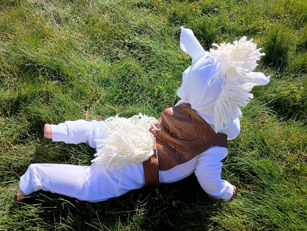 Back view of a baby in a Tangled Rapunzel costume