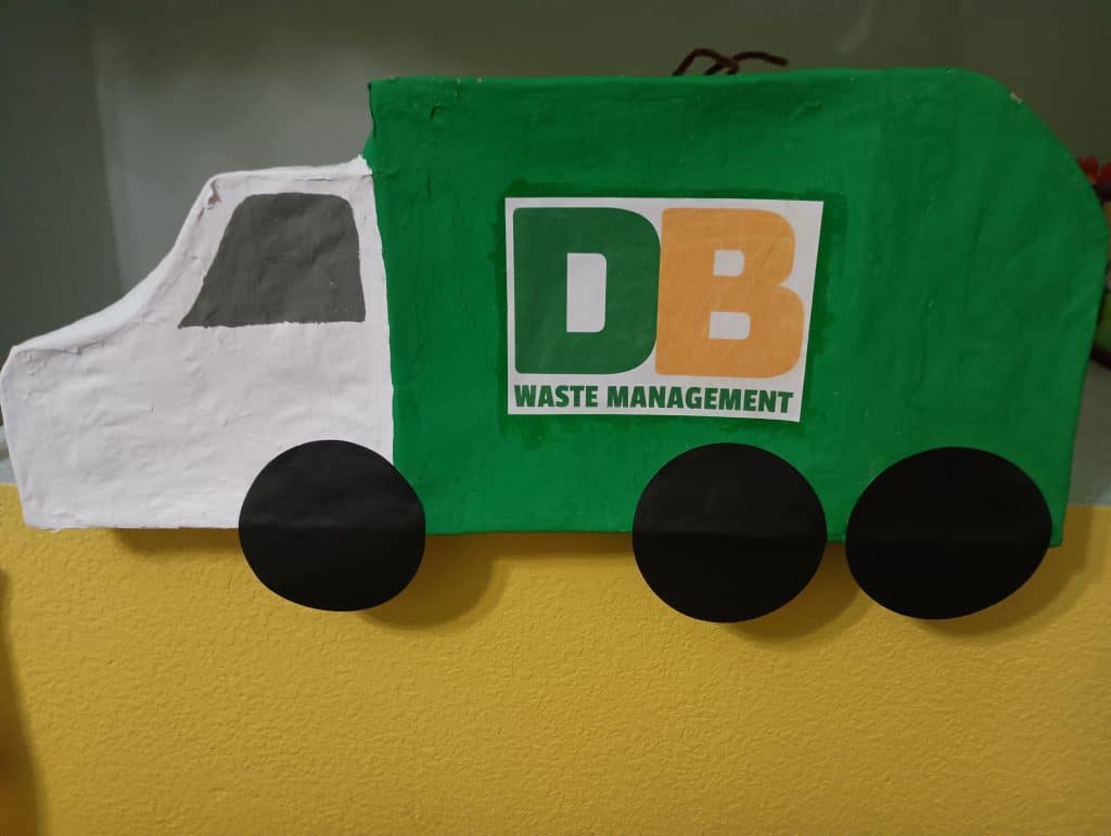 Side view of a DIY trash truck pinata made for a garbage truck birthday party