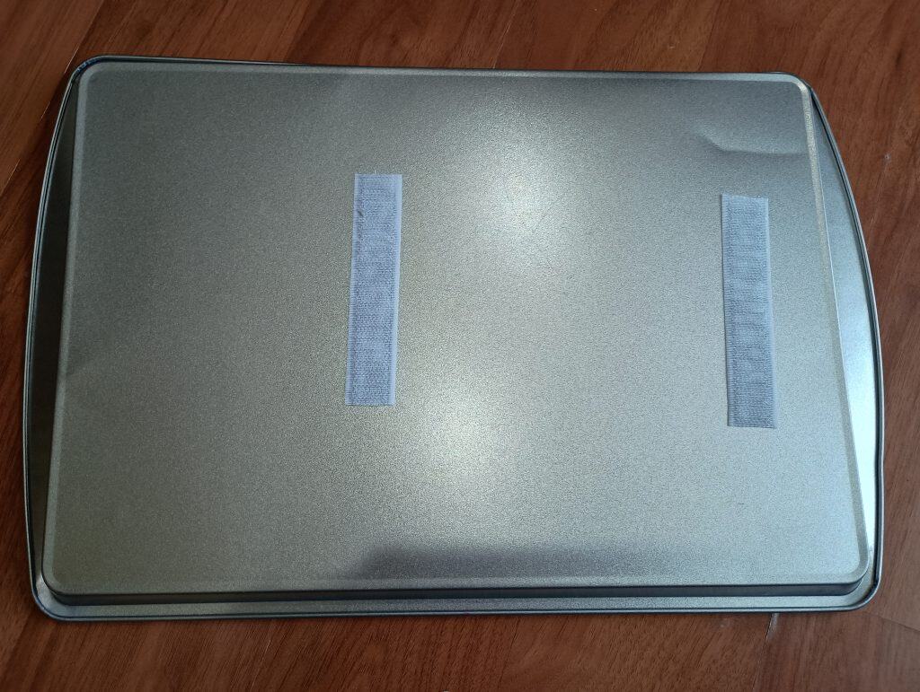 Picture of two Velcro strip on the back of a cookie sheet